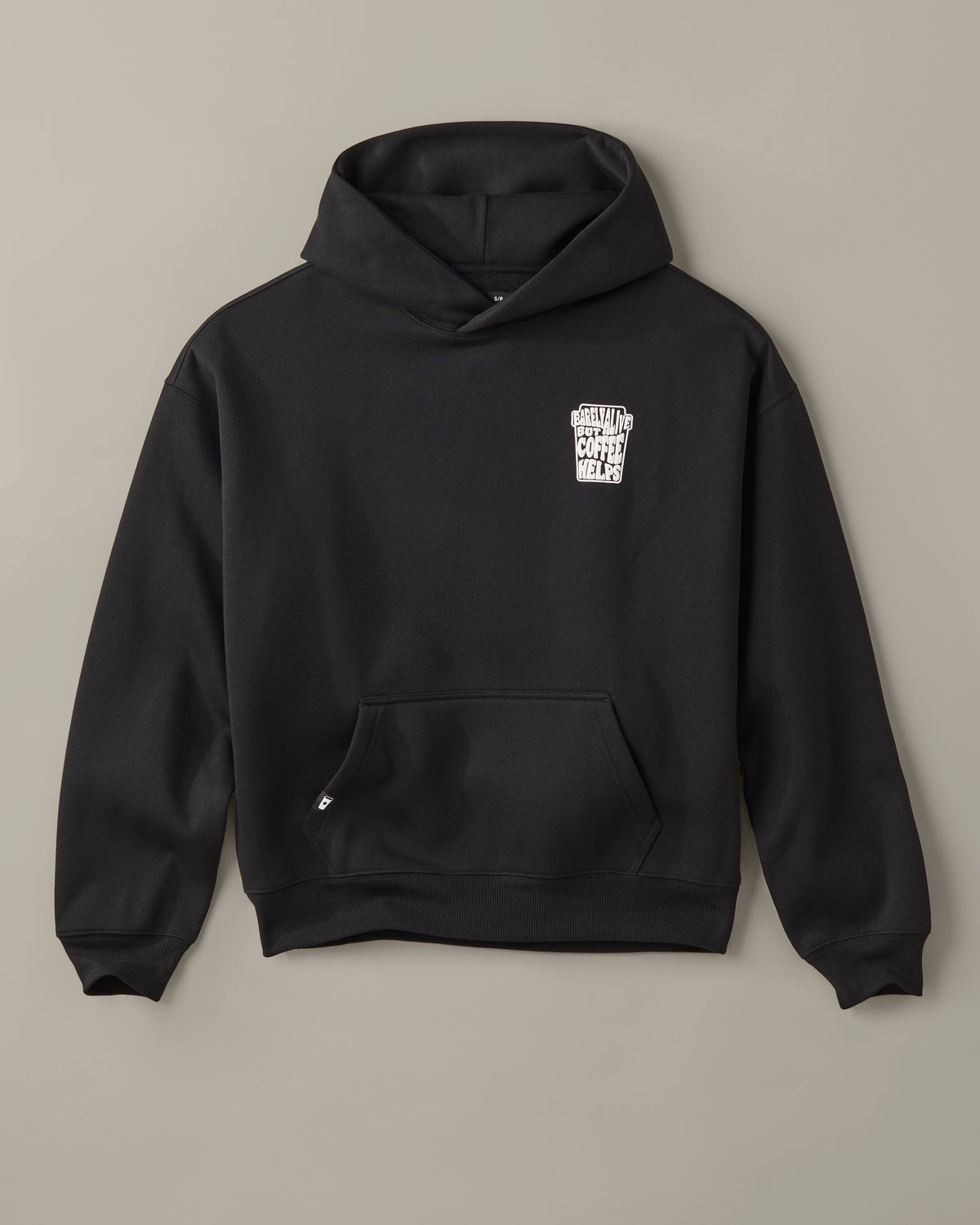 Black unisex pullover hoodie with a small white Barely Alive graphic on the chest. | Chandail à capuchon unisexe noir avec design « Barely Alive » sur le torse. - Image #3