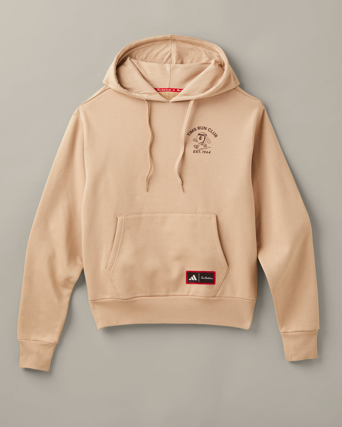 Cream adidas® pullover hoodie with a Tims Run Club donut character on the chest, kangaroo pocket, and co-branded patch. - Image #2