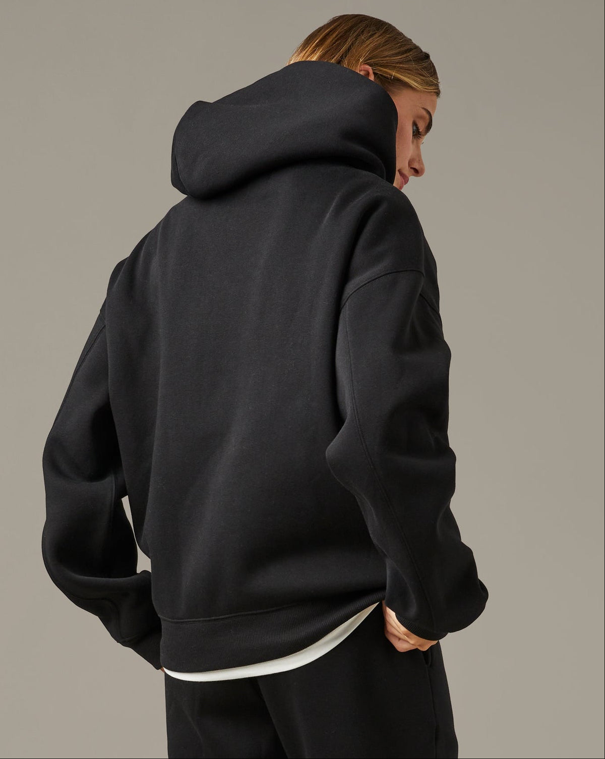 Black unisex pullover hoodie with a small white Barely Alive graphic on the chest. | Chandail à capuchon unisexe noir avec design « Barely Alive » sur le torse. - Image #2