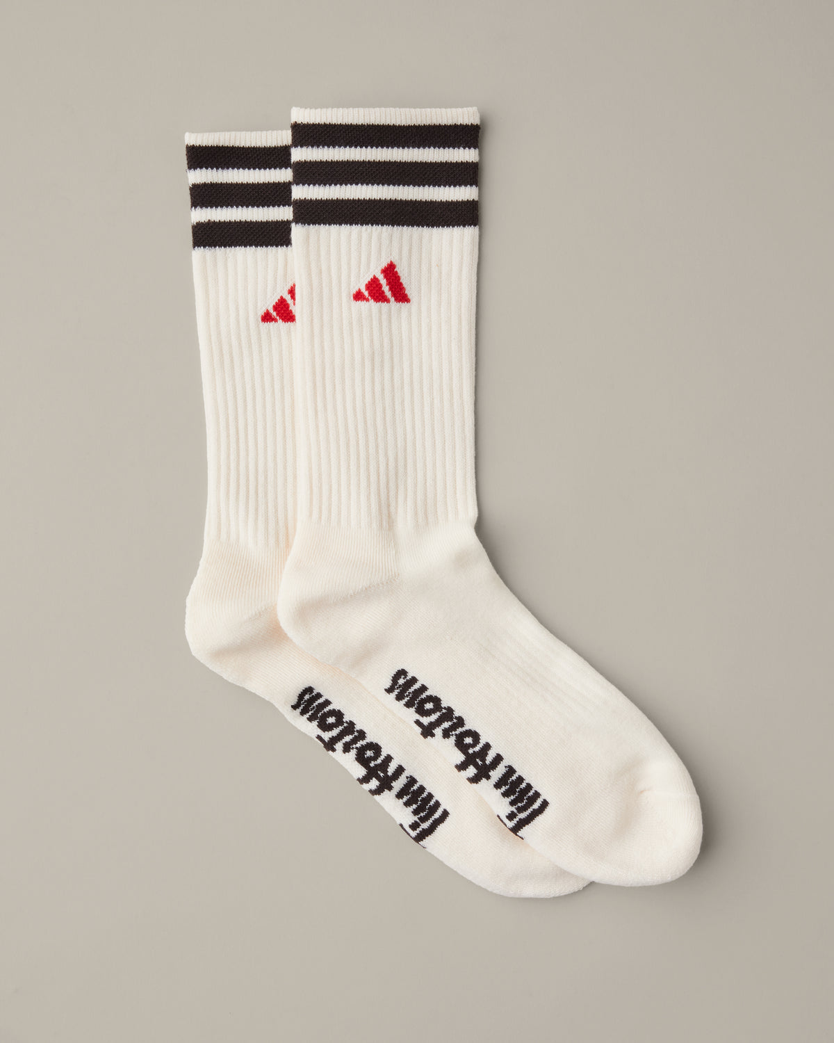 Three pairs of women’s adidas® crew socks in tan, cream, and espresso brown with striped cuffs and red adidas® logos. - Image #2