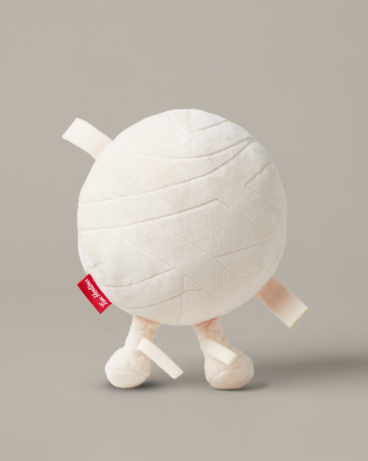 Timbits® Mummy plush with white wrapping, an embroidered face and black-and-white striped legs. | Peluche momie TimbitsMD avec bandelettes blanches, visage brodé et jambes rayées noir et blanc. - Image #2