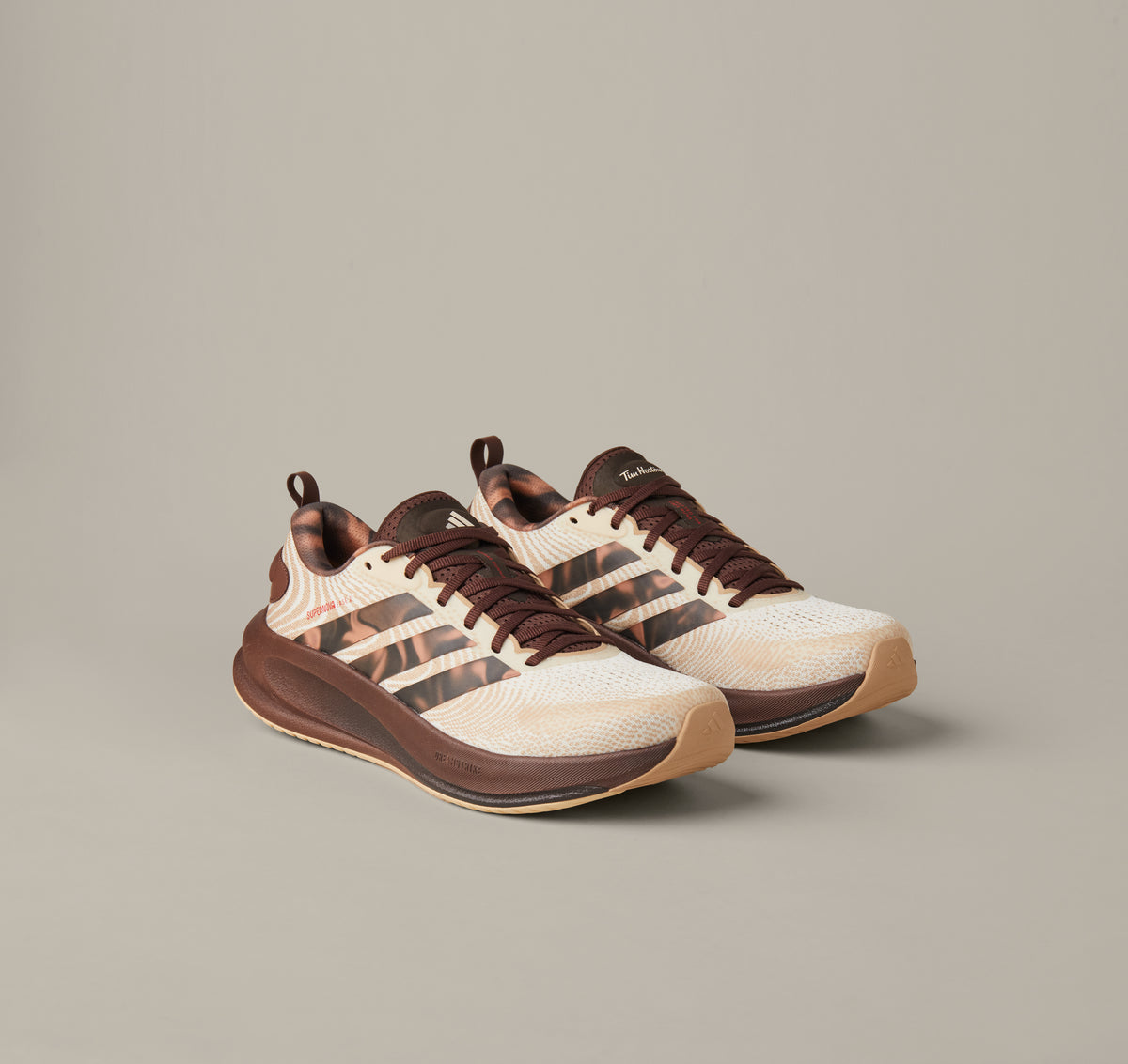 Men’s adidas® Supernova Ease running shoes in cream and coffee-brown shades with patterned 3-Stripes and Tim Hortons details.