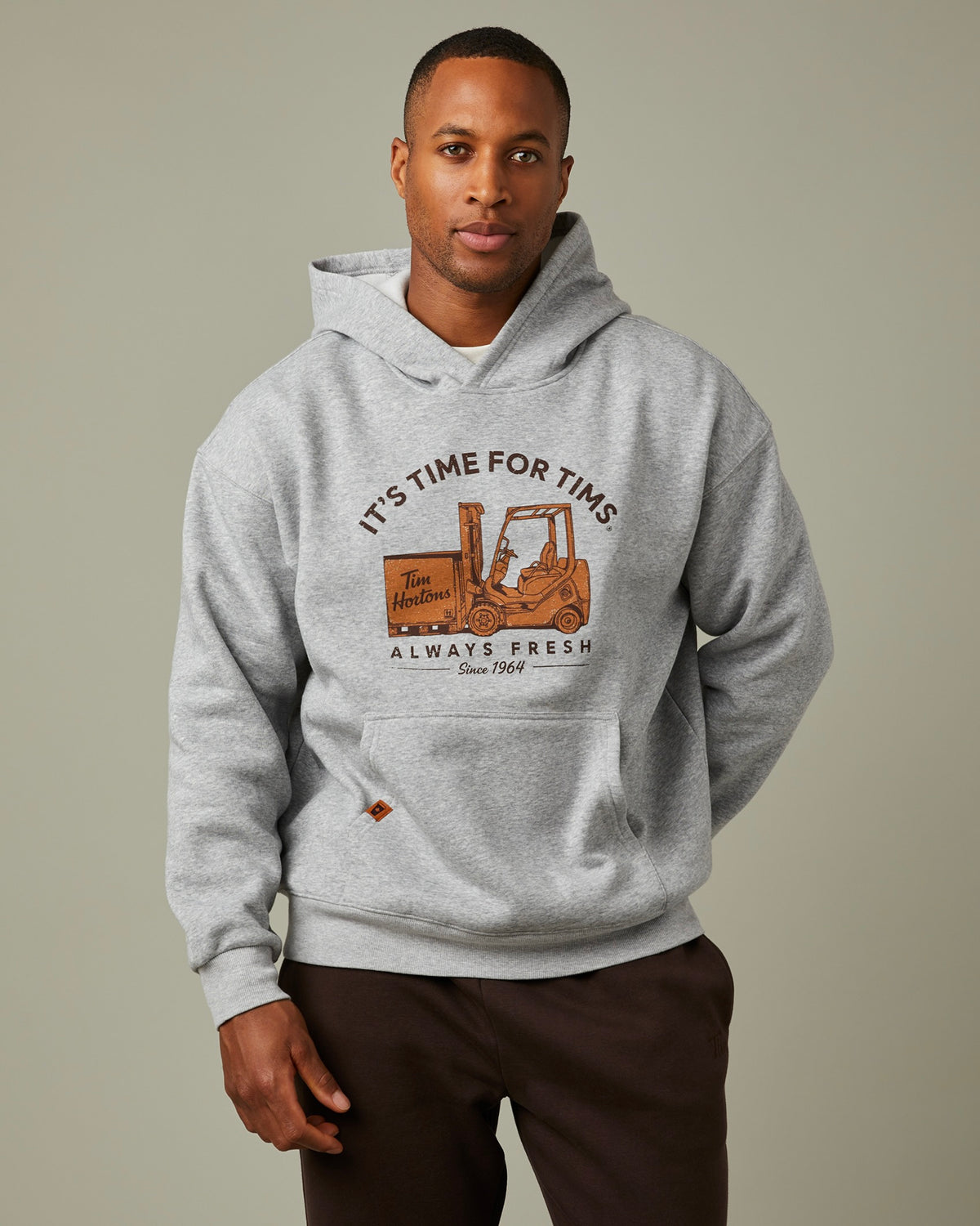 Grey hoodie with “It’s Time for Tims” graphic featuring a forklift carrying Tim Hortons coffee | Chandail à capuchon gris avec un logo « It’s Time for Tims » montrant un chariot élévateur transportant un café Tim Hortons - Image #1